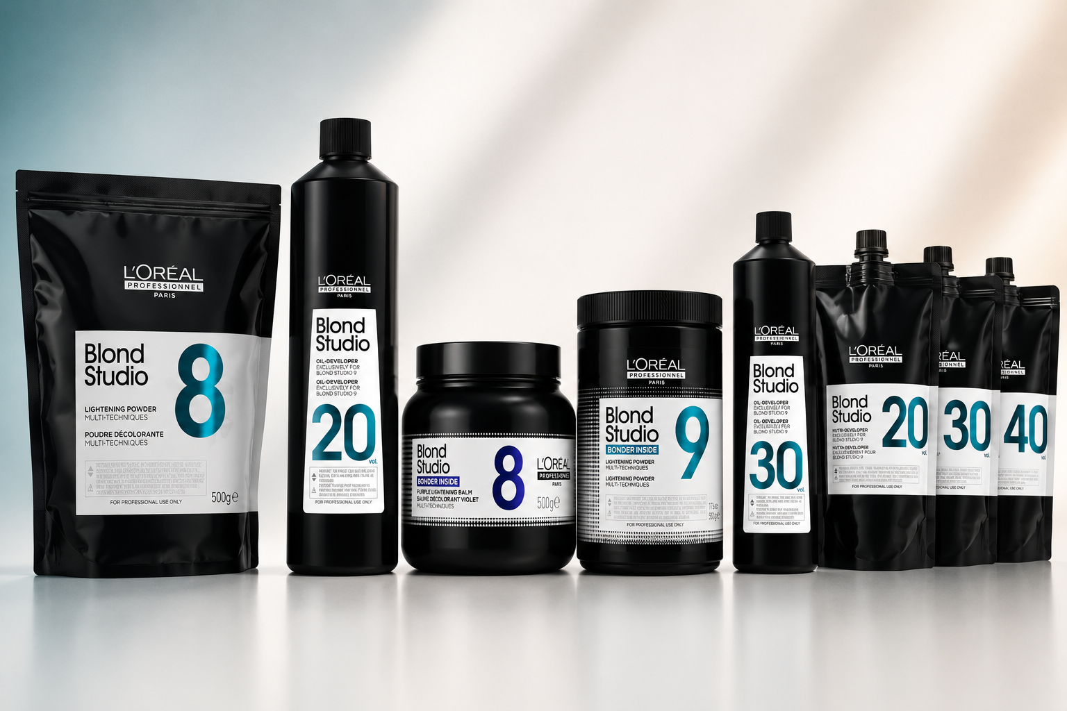 L'Oréal Professionnel Blond Studio lightening powders, bonders and developers displayed on a clean white background with soft blue accents.