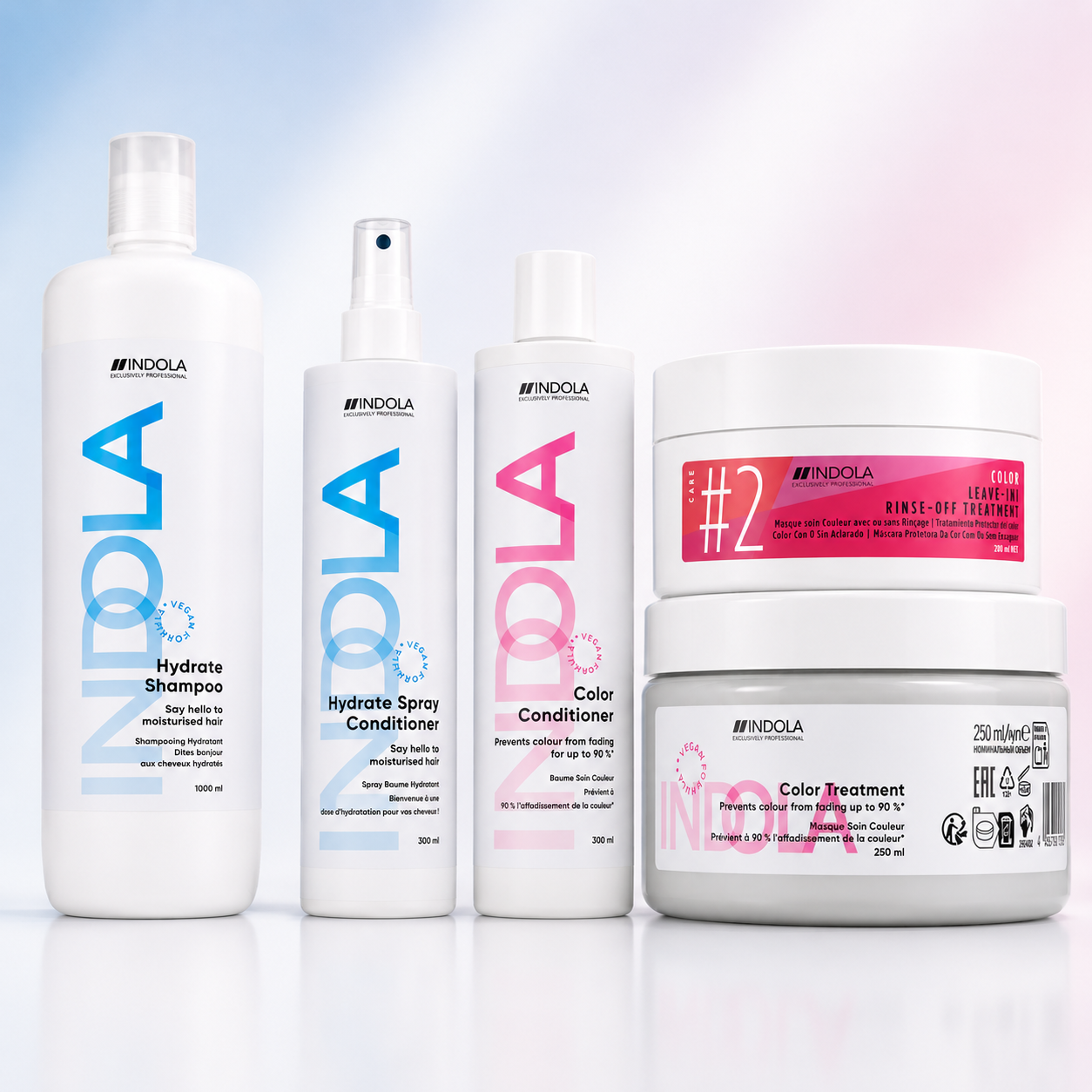 Indola hydrate and colour care products displayed on a soft pastel blue and pink background.