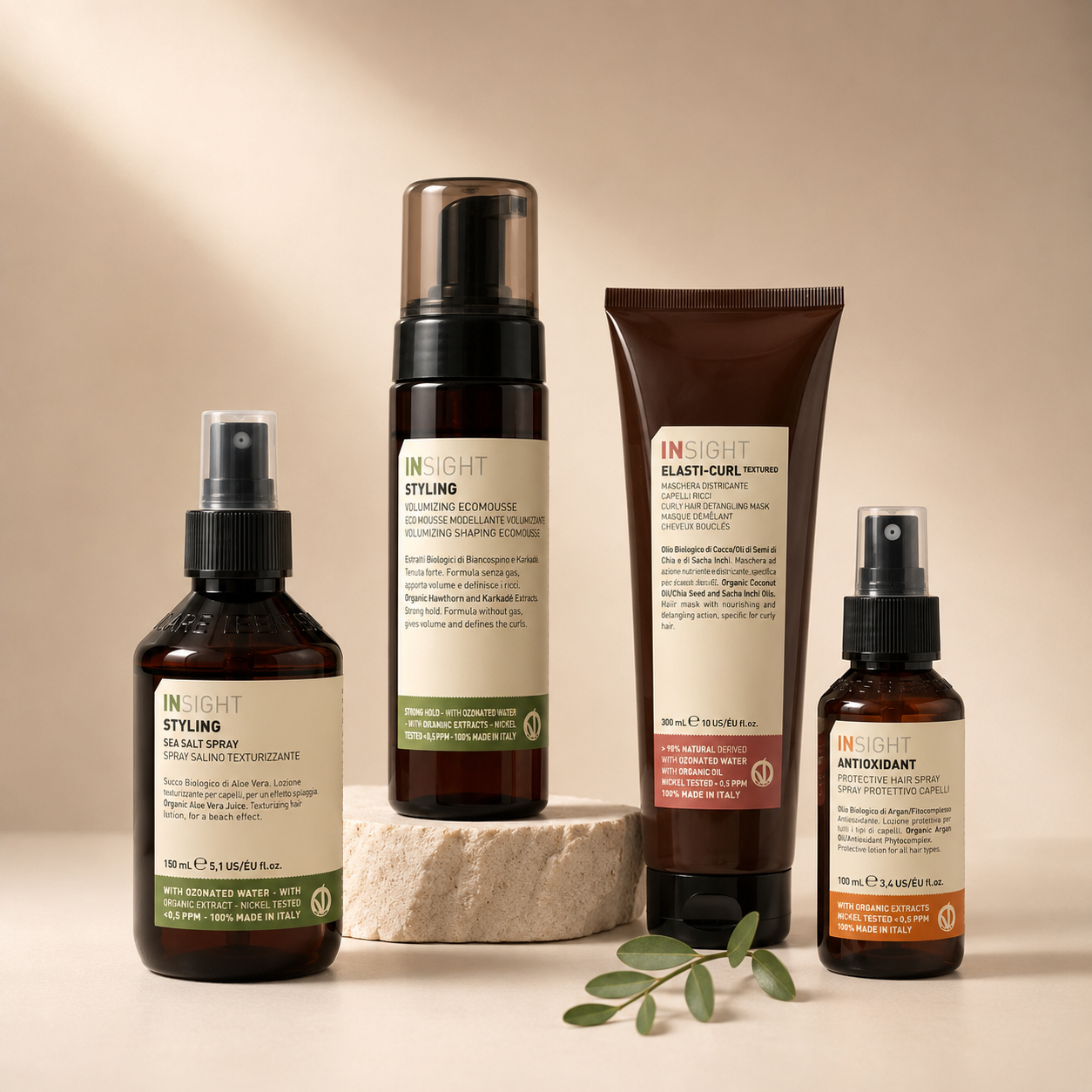 Selection of Insight Professional styling and treatment products displayed on a premium neutral gradient background with a clean, minimalist salon aesthetic.