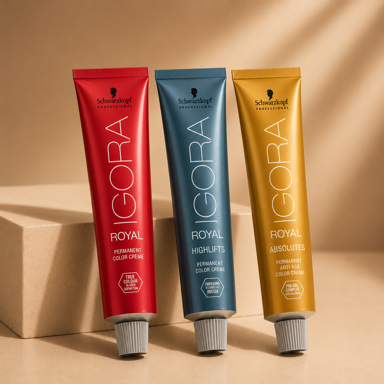 Three Schwarzkopf IGORA Royal hair colour tubes displayed on a premium beige gradient background, featuring Royal, Highlifts and Absolutes ranges.