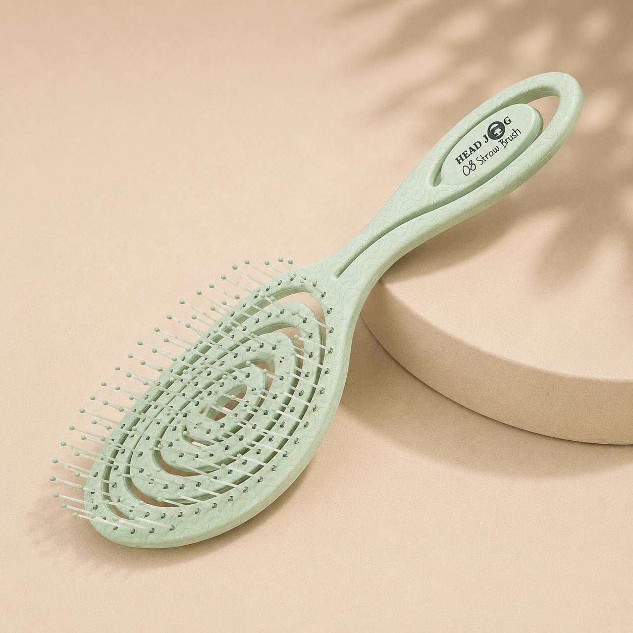 Minimalist collection image featuring a mint green Head Jog Straw Brush on a soft neutral background with subtle natural shadows.